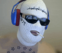 a person wearing a ski mask has the word not embroidered on their face