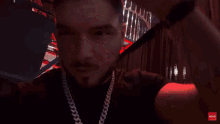 a man wearing sunglasses and a chain is kissing a woman