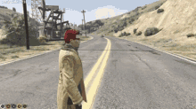 a man in a native american outfit is standing on a road in a video game