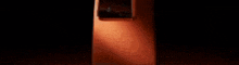 a close up of a cell phone with a broken screen on a red background .