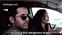 a man and a woman are in a car and the man is saying " enjoying this dangerous chase " .