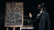 a man in a suit stands in front of a display board that says ' demar windos '