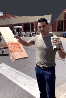 a man holding a bag that says home depot on it