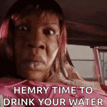 a woman is sitting in a car with her mouth open and the words hemry time to drink your water .