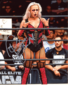 a woman in a wrestling ring is signed by a female wrestler