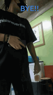 a person wearing a shirt that says " this is never that "