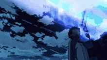 a man stands in front of a blue sky with a few clouds