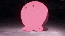 a pink cartoon character with a smiley face is standing on a dark surface .