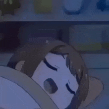 a cartoon girl is sleeping in a bed with a blanket on her head .