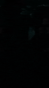 a person is hanging upside down in a dark room with a red box that says ' a ' on it