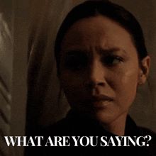 a woman with a serious look on her face and the words what are you saying