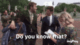 a man in a suit is being interviewed by a woman who says do you know that ..