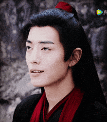 a close up of a man 's face with chinese characters on the bottom left