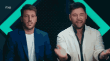 two men standing next to each other with rtve written in the corner