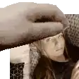 a person is petting a woman 's head with a towel .