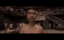 a man is hitting another man in the face in a crowded area .
