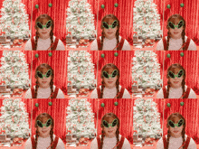 a girl wearing alien glasses stands in front of a white christmas tree