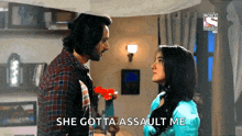 a man and a woman are looking at each other and the woman says she gotta assault me .
