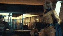 a man in a yellow superhero costume is standing in front of a window