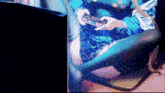 a girl is playing a video game with a controller