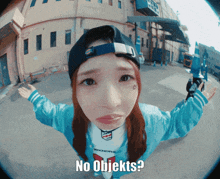 a girl wearing a hat and a shirt that says ' no objekts '
