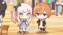 a boy and a girl are standing next to each other and the girl is wearing a blue dress with a bow on it .