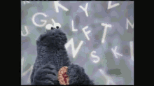 a cookie monster is surrounded by letters including g l f t n v s k and l