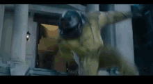 a person in a yellow suit is standing in front of a building