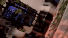 a blurred image of a computer monitor with a few leaves on top of it