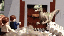 a group of lego figures are standing in front of a door looking at a dinosaur .