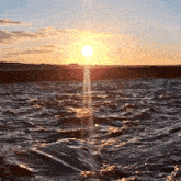 the sun is setting over a body of water with waves