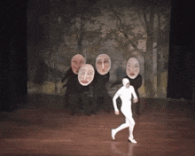 a man in a white suit with a hood is holding his face