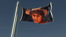 a flag with a picture of a man in a cowboy hat
