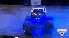 a monster jam monster truck is driving on a stage