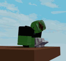 a cartoon character with a green head is sitting on a table