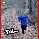 a woman in a blue jacket is running on a trail with the word yei written on the bottom