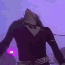 a man in a black outfit is dancing in front of a drum set