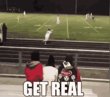 a group of people are watching a football game with the words get real written in the foreground