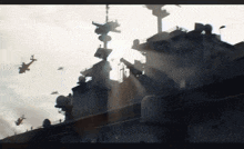 a helicopter is flying over a large ship with the sun shining through it