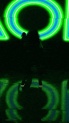 a person is standing in front of a green and blue sign that says aol