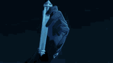 a hand in a black glove is holding a very long object