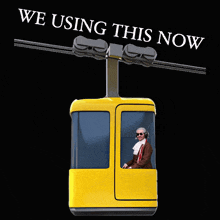 a man is riding a yellow cable car with the words " we using this now " above it