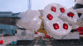 a white item with red stones on it