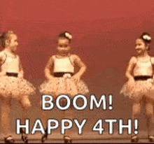 a group of little girls are dancing on a stage with the words `` boom ! happy 4th '' .