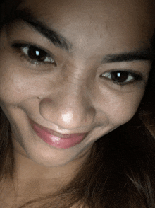 a close up of a woman 's face with her eyes closed