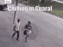 a man and a woman are walking down a street with the words `` chilling in guaral '' written on the bottom .