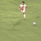 a soccer player with the number 16 on his jersey kicks the ball