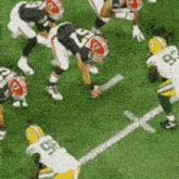 a group of football players are playing on a field and one of them has the number 23 on his jersey