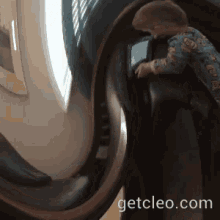 a little boy is playing on a roller coaster with the website getcleo.com in the corner