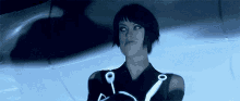 a woman in a futuristic outfit with a triangle on her arm